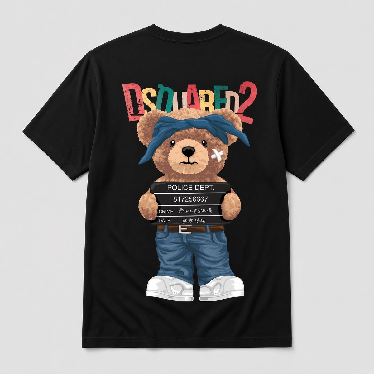 A black short-sleeve T-shirt shown flat against a light gray background, featuring a large teddy bear graphic on the front. The bear wears a blue bandana, blue shorts, and white sneakers, and holds a police block.