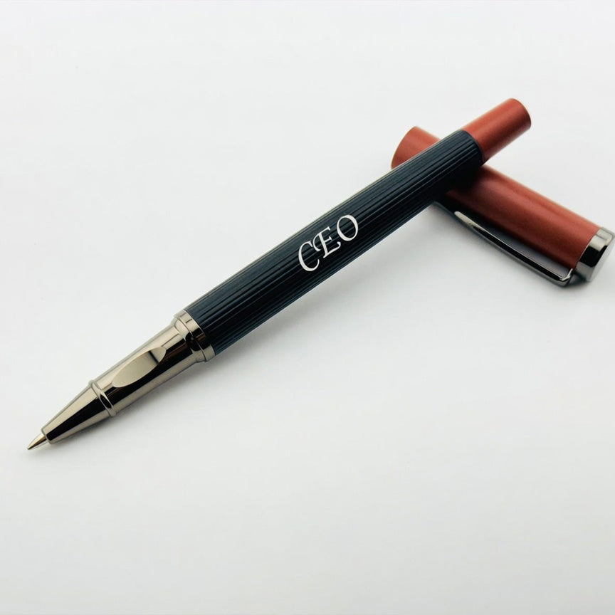 A personalized ballpoint pen with a dark ribbed barrel, silver metal accents, and a reddish-brown cap, shown on a plain light background.
