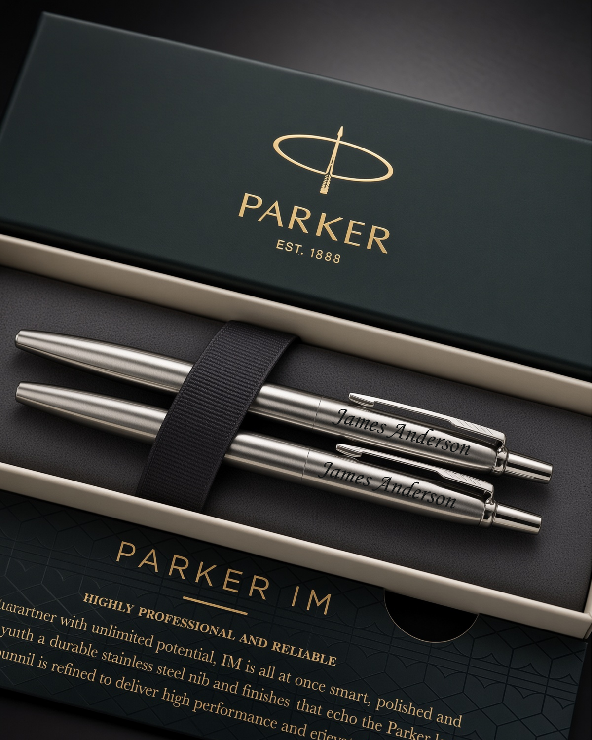 Three personalized Parker IM ballpoint pens in polished silver stainless steel, presented in an open dark green and beige gift box with a black ribbon. The box lid features the gold-foiled 'PARKER' logo, and the bottom insert card displays the 'PARKER IM' branding.