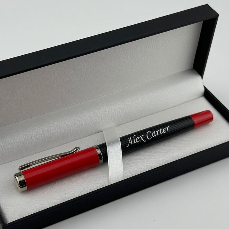 A red and black personalized ballpoint pen with 'Alex Carter' printed on it, presented inside an open black gift box with a white interior. The words 'Executive Pen' are printed in black at the bottom right corner.