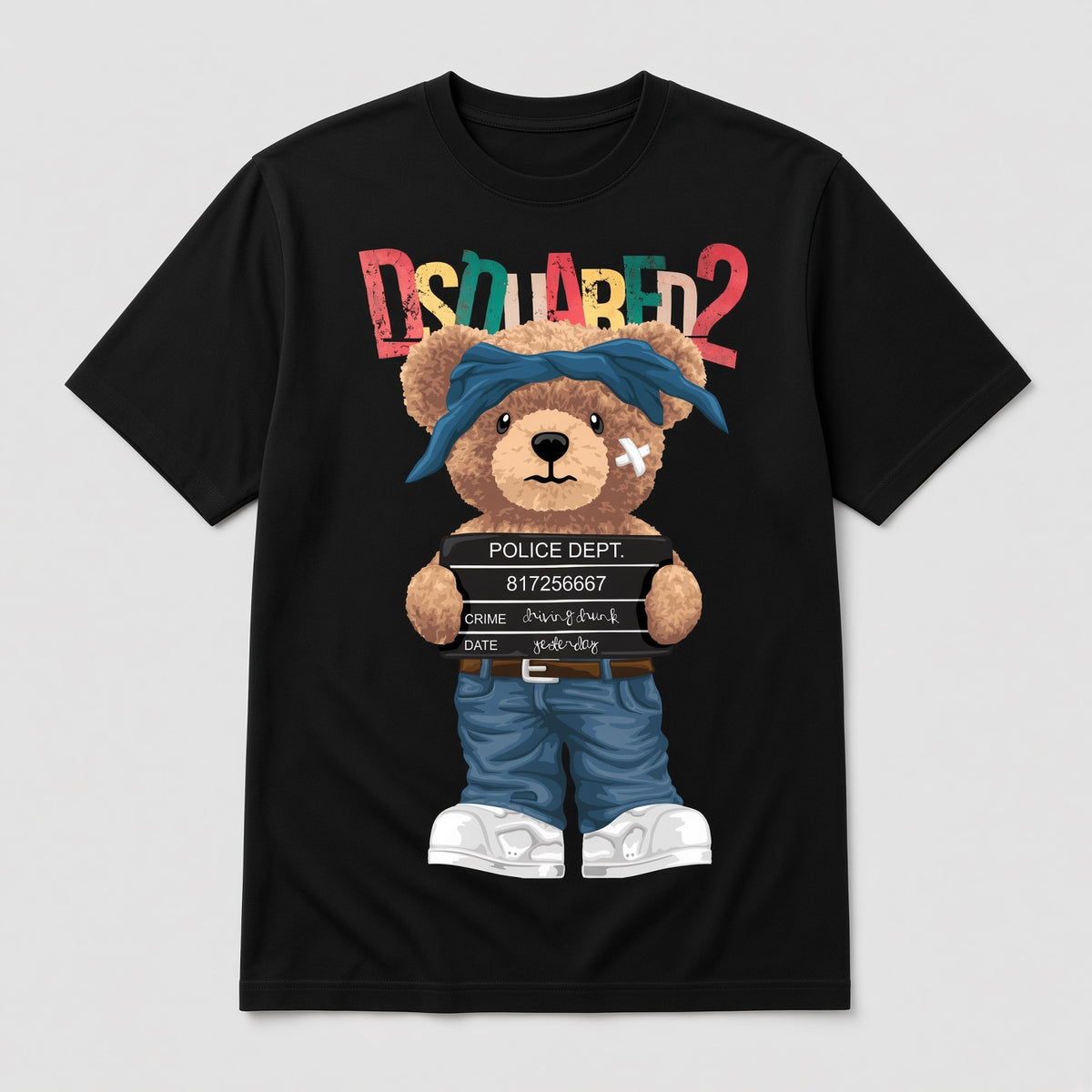 A black short-sleeve graphic T-shirt on a light gray background. The shirt features a cartoon teddy bear wearing blue jeans and a blue bandana, holding a police report clipboard, with the word 'DSQUARED2' printed above in multicolored letters.