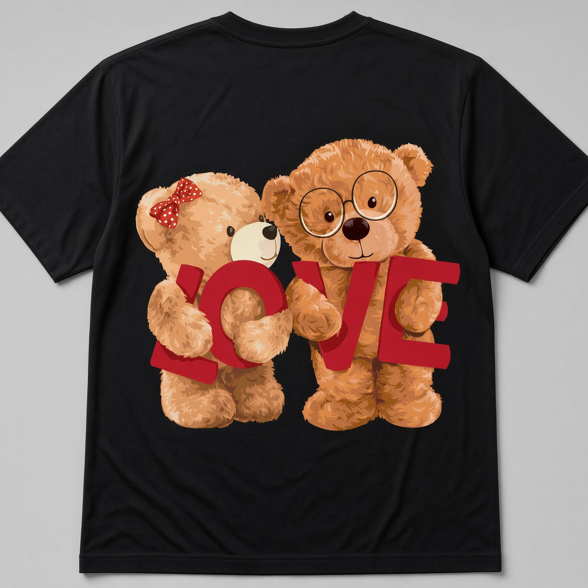 A black short-sleeve t-shirt with a graphic print of two teddy bears hugging and holding the word 'LOVE' in red letters, shown against a neutral gray background.