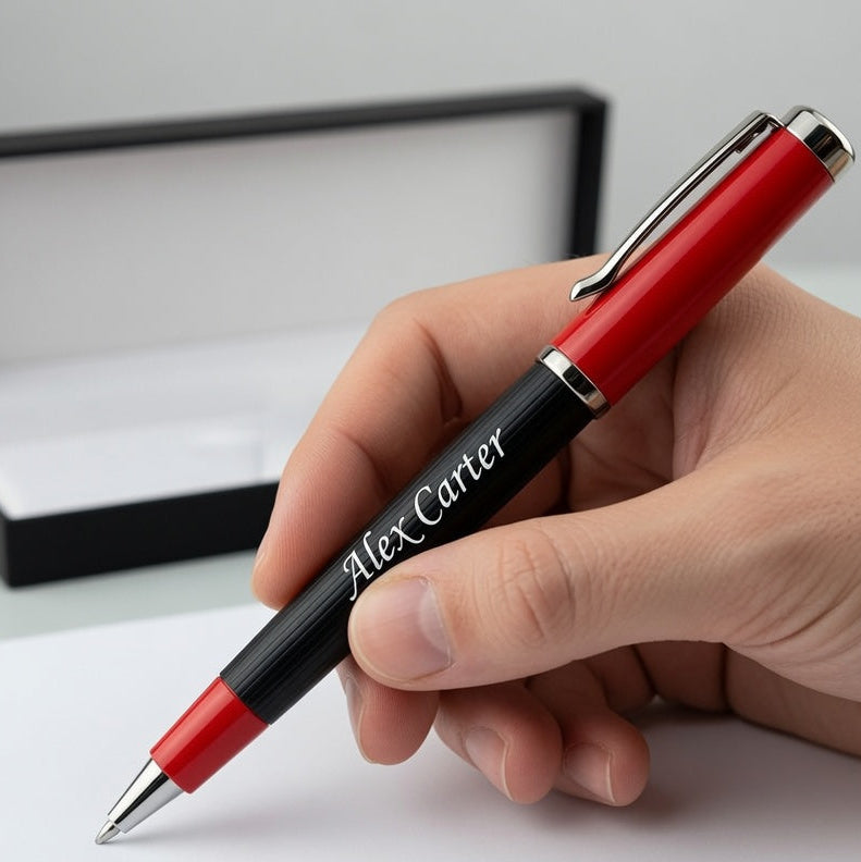 A hand holding a red and black personalized ballpoint pen with 'Alex Carter' engraved on the barrel, with an open black presentation box in the background and the text 'Executive Pen' in the bottom right corner.
