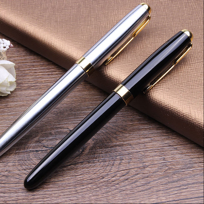 Two fountain pens, one silver and one black, both with gold accents, displayed diagonally on a brown textured book over a wooden surface. The brand name 'XIER' is visible in the top left corner.