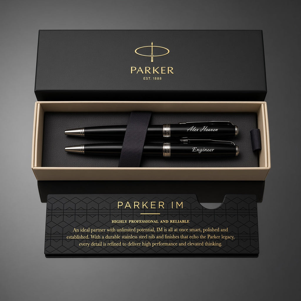 Parker IM pen set in an open black presentation box with gold trim, shown on a dark gray background. The set includes three black pens with silver and gold accents, a black ribbon, and branded packaging.