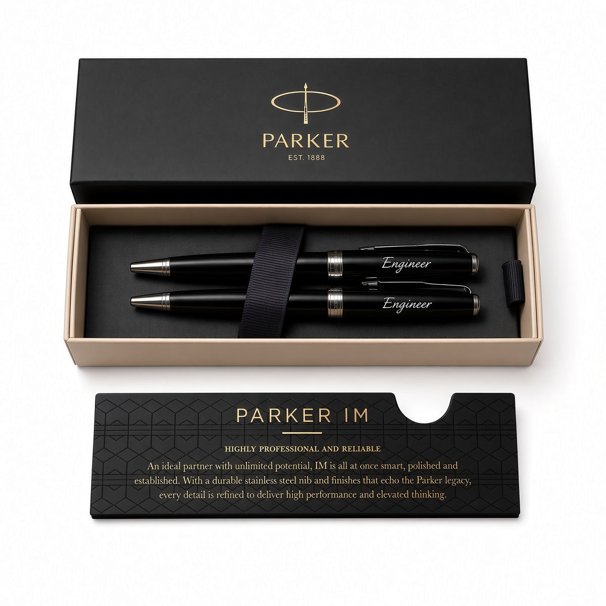 Parker IM pen set in a black presentation box with a matching black card, photographed on a clean white background. The set includes two black pens with silver and gold accents, a black ribbon, and branded packaging.