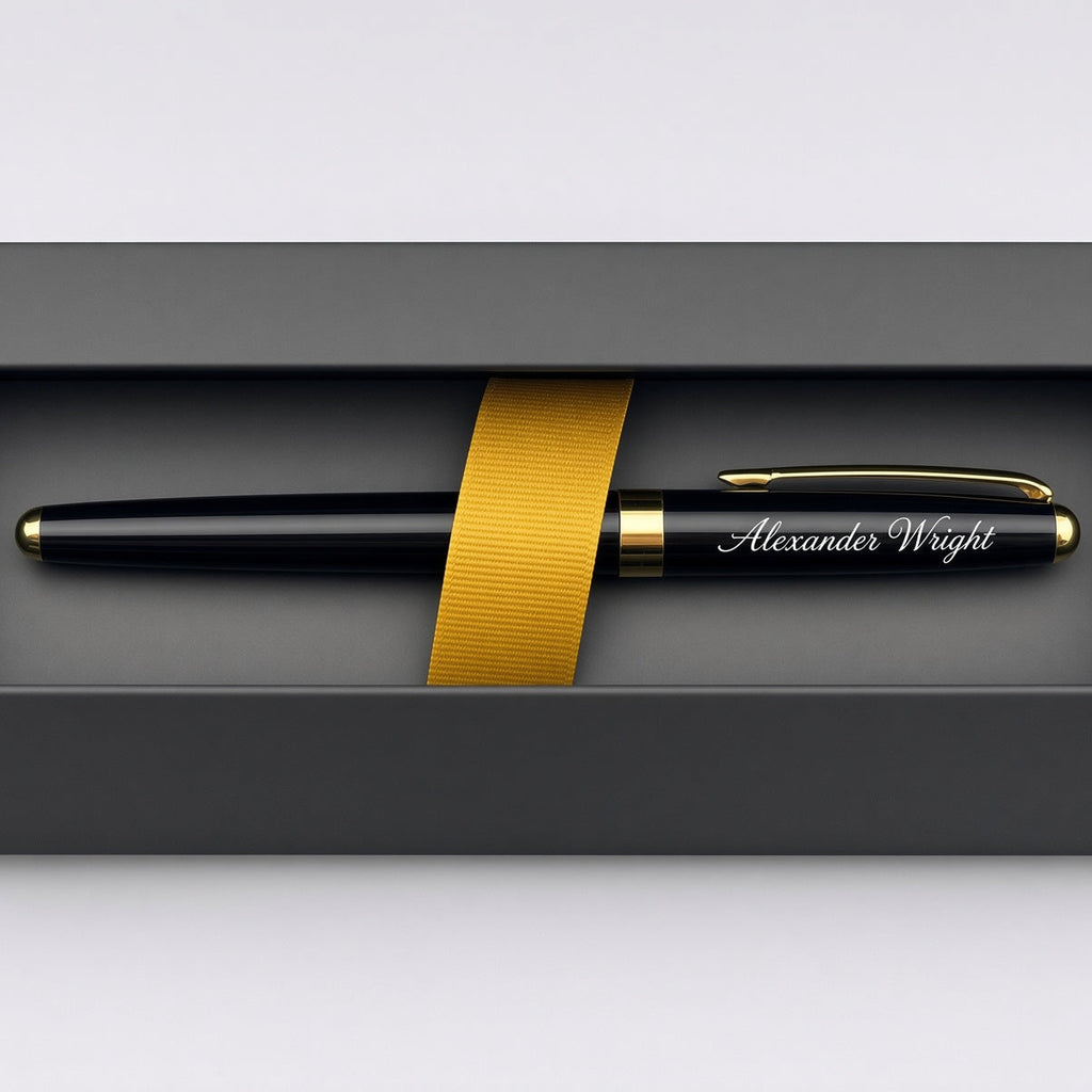 A personalized black pen with gold trim and the name 'Alexander Wright' engraved on the clip, presented inside a dark gray gift box with a gold ribbon.