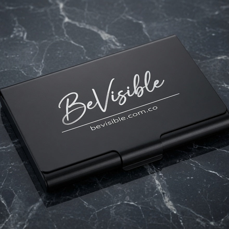 A black metal business card case with 'BeVisible' and 'bevisible.com.